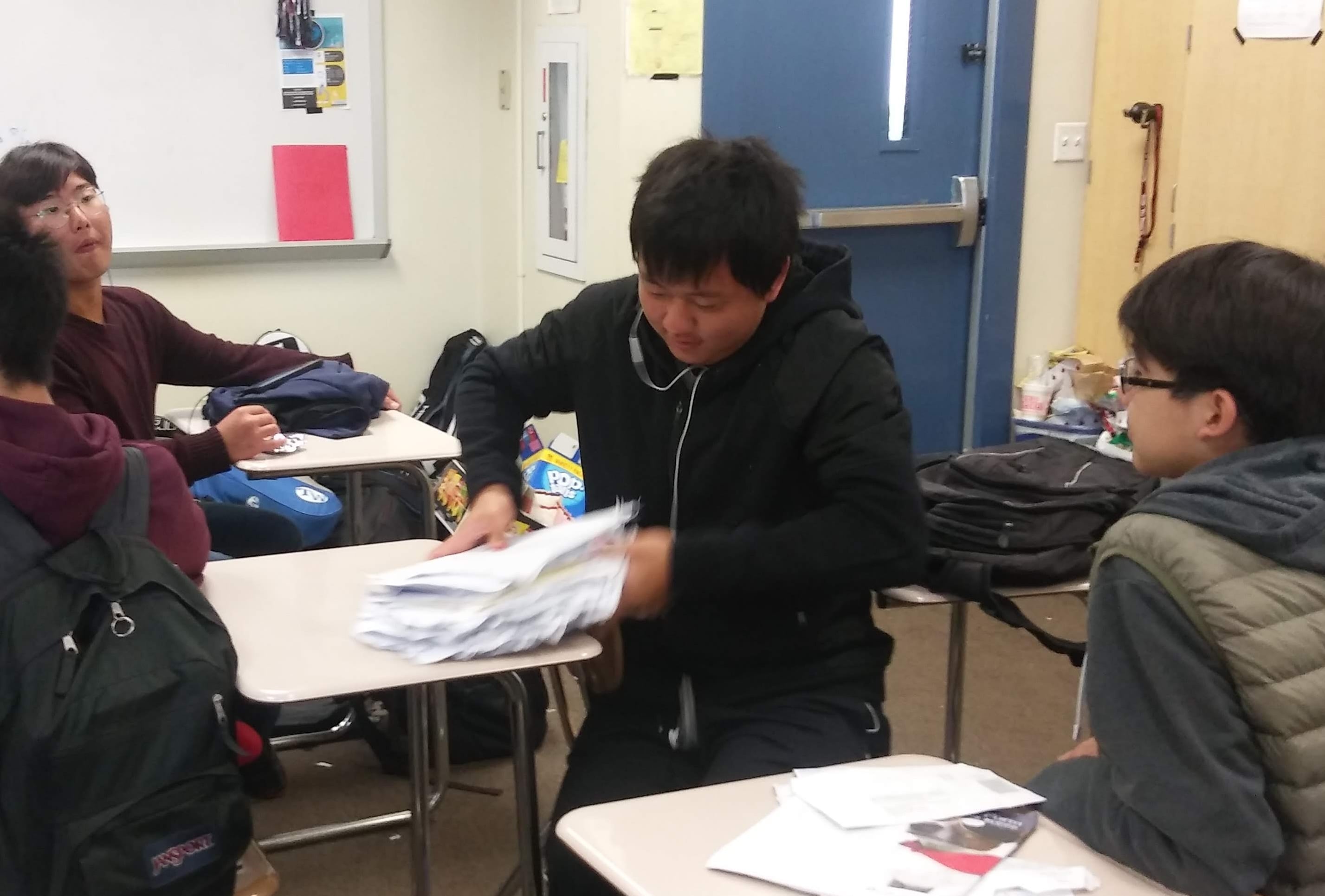 Gary shoving papers in his backpack
