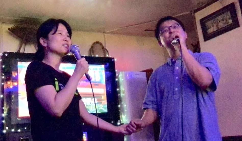 Aunt holding hands and singing with Uncle