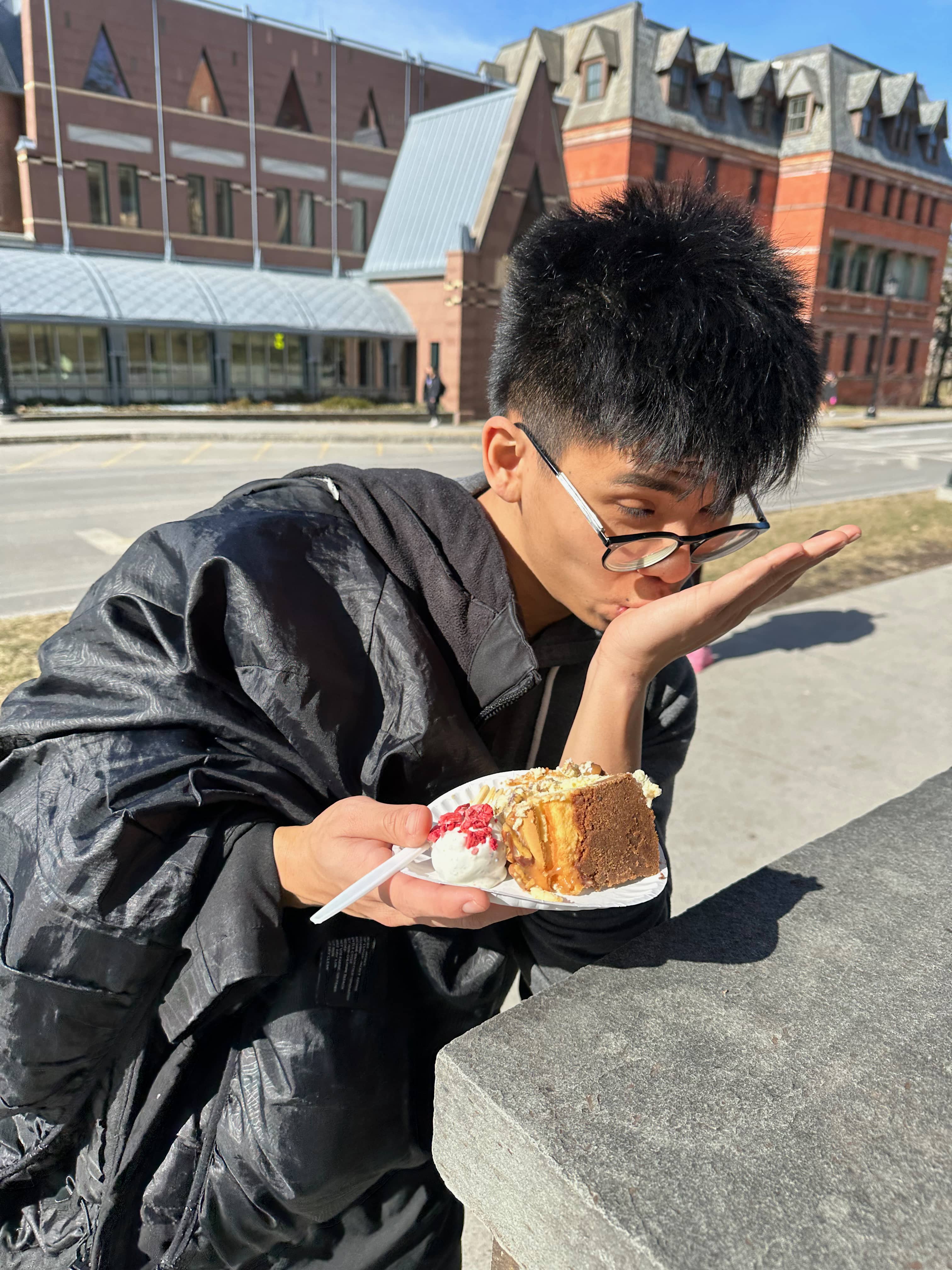 Max licking cake off his hand