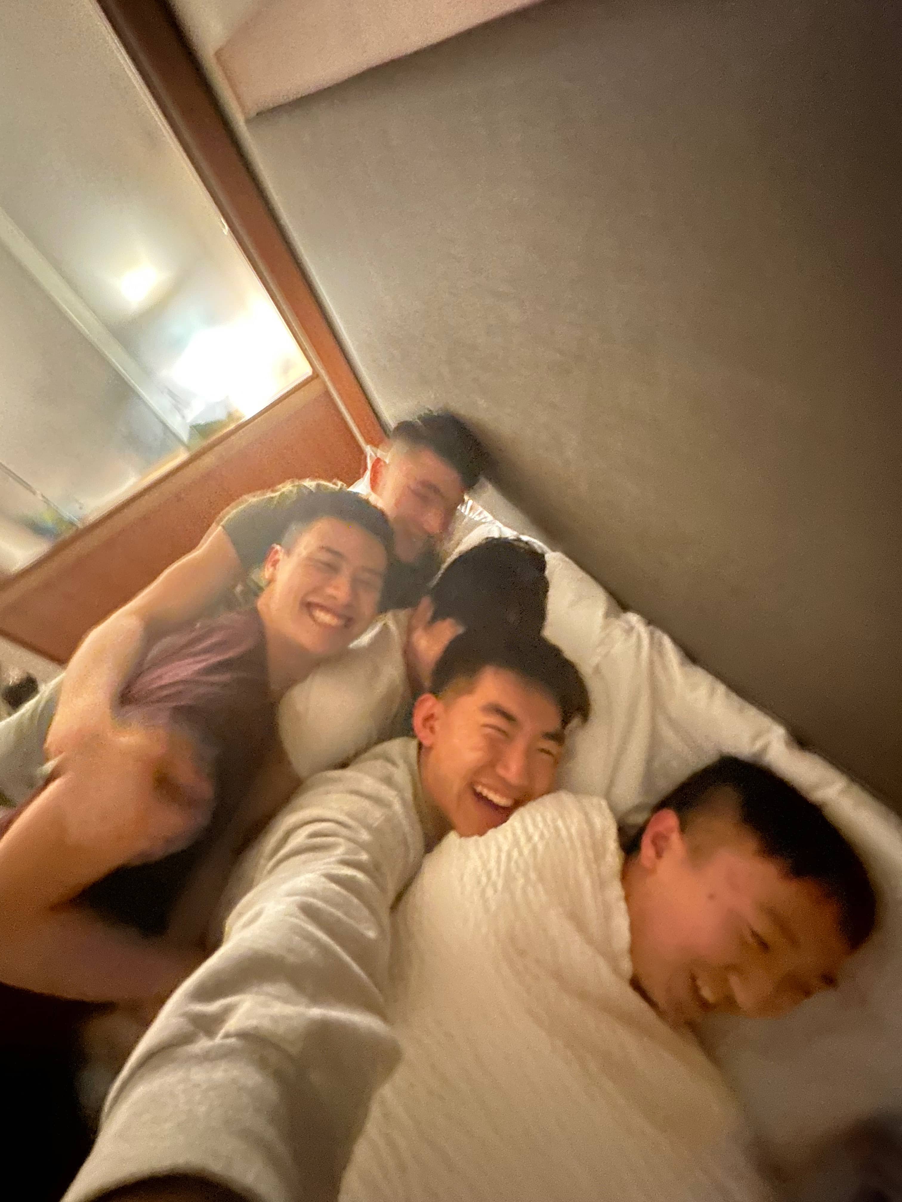 Five guys on a bed
